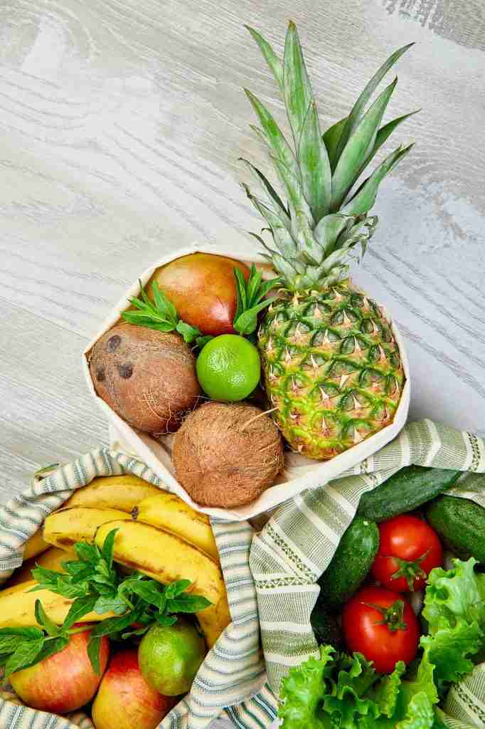 Eco friendly grocery bags with organic fruit and vegetables